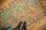 Vintage Moroccan Murat runner close-up, displaying thick pile with aqua blue and orange reciprocating patterns.
