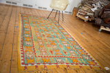 Vintage Murat runner's thick pile, showing mint green field and orange reciprocating patterns.