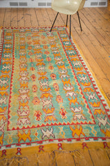 Secured golden fringe and repeating geometric patterns on a vintage Moroccan Murat runner end.