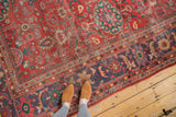 Antique Sultanabad carpet's unique lavender border and coral-red field with distressed floral motifs.