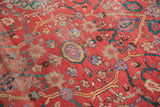 Persian Antique Sultanabad rug detail, coral-red field, lavender-mauve floral motifs, even worn pile.