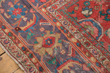 Unusual lavender-purple border and coral-red field of antique Sultanabad, with pile worn to knot heads.