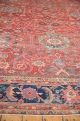 Worn coral-red antique Sultanabad rug, sapphire border, lavender floral motifs, exposed knot heads.