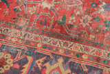 Unique lavender-purple border on antique Sultanabad rug's coral-red field, worn to knot heads.