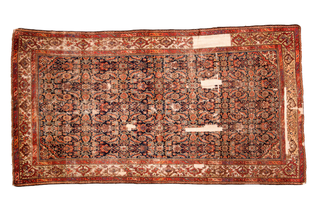 Collector antique Fereghan carpet, allover Herati on dark indigo, rich hues, with storied wear.