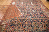 Antique Fereghan carpet showcasing Herati design, rich hues on indigo, time-softened lime green border.