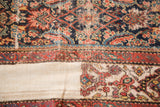 Antique Fereghan Herati pattern in indigo, brick red, and green meets the plain weave foundation.