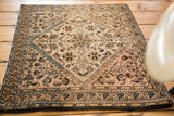 Blossoming flower medallion and delicate tendrils on the antique Farahan Sarouk rug.