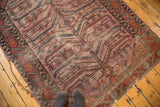 Distressed antique Lilihan rug featuring exaggerated serrated motifs in mauve, terracotta, and soft blue tones.