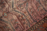 Distressed antique Persian Lilihan rug: mauve, terracotta field with serrated agricultural motifs and dark border.