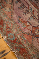 Unique serrated motifs on distressed antique Lilihan rug, with mauve and blush red tones.
