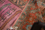 Antique Lilihan rug's vibrant mauve and terracotta pile with distressed texture and serrated patterns.