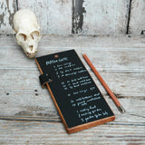 Handmade black chalkboard tablet with wood frame, leather strap, and chalk pencil.