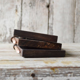 Stacked handmade chalkboard tablets showing rustic wood edges and white chalk pencils.
