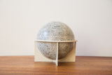 Collectible vintage 6-inch moon globe displaying grey crater texture on a retro plastic base.