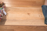 Textured reclaimed wood surface of the bench, featuring natural grain and a wood knot.