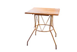 Handmade reclaimed square wood table with yellow metal geometric base.