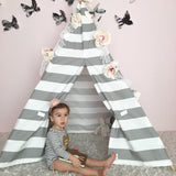 Kids gray and white stripe teepee with child, unicorn, and book inside.