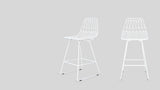Lower section of two white wire counter stools, highlighting legs and footrests.