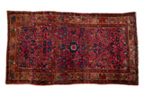 Painted Vintage Persian Merhaban rug, dynamic raspberry field, floral design, visible white knots.