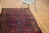 Vintage Merhaban rug's traditional floral border and raspberry field with white knots.