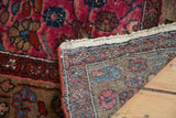Vintage Persian Merhaban rug pile with raspberry field, white knots, and visible hand-knotted back.