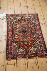 Vibrant fluorescent pink border and jewel tone floral motifs on a vintage Persian Hamadan rug.