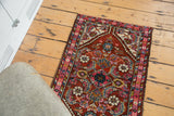 Fluorescent blush pink border and jewel-toned patterns of a vintage Persian Hamadan rug.