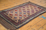 Zig-zag and wave motif borders framing serrated guls on a natural camel field.