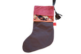 Antique Rug Fragment Stocking with fuchsia suede cuff, dark linen, and geometric rug fragment.