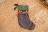 Holiday stocking's black leather tassel and luxurious green suede cuff with an antique rug fragment band.