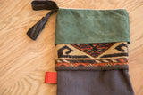 Green suede cuff and geometric rug pattern on a stocking with a black leather tassel.
