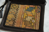 Interior flap of the bag lined with a geometric Caucasian rug fragment and silver magnetic snaps.