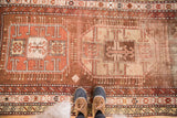 Antique Caucasian runner's bold geometric triple medallion pattern in bronze, copper, and ivory tones.