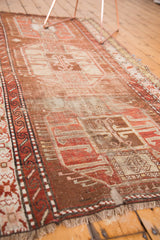 Hand-knotted Caucasian rug with time-softened geometric border and bronze, copper, ivory palette.