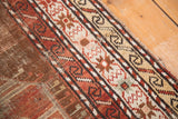 Antique Caucasian runner's geometric border, bronze, copper, and ivory tones, with isolated distress.