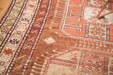Hand-knotted Caucasian runner with geometric motifs in bronze, copper, and ivory.