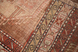 Worn geometric patterns with bronze, copper, and ivory on an antique Caucasian rug runner.