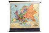 Vintage Cram's pull down map of Europe, showing colorful 1930s political boundaries with wood dowels.