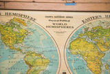 Vintage Cram's World Hemispheres map, central title, aged green land, and blue oceans.