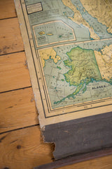 Frayed lower edge of the vintage Cram's map, revealing its rolled dowel and Alaska region.