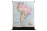 Vintage 1937 Cram's pull-down map of South America, vibrant countries, light blue ocean.