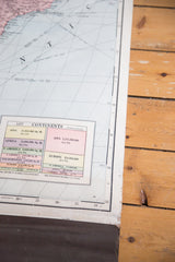 Vintage 1937 Cram's map detail showing continent data tables and paper edge wear.