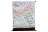 Vintage Cram's pull down map of Asia & Australia, pastel colored countries, torn bottom.