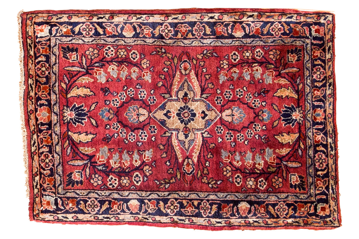 Vintage Sarouk rug mat with wine red field, floral bouquet medallion, and navy blue borders.
