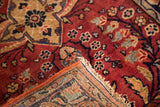 Hand-knotted Sarouk rug mat corner, showing secured red side, fringe, and floral pile.