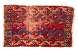 Antique Yastic rug mat featuring a faded raspberry red field with vine and floral motifs, 1'7