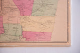 Close-up of an antique 1860s Putnam County map showing color-tinted districts and towns.