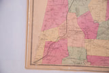 Decorative border and hand-colored regions on the left side of an antique NY county map.