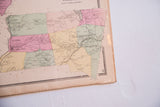 Corner detail of the antique New York map, showing aged paper and decorative border.